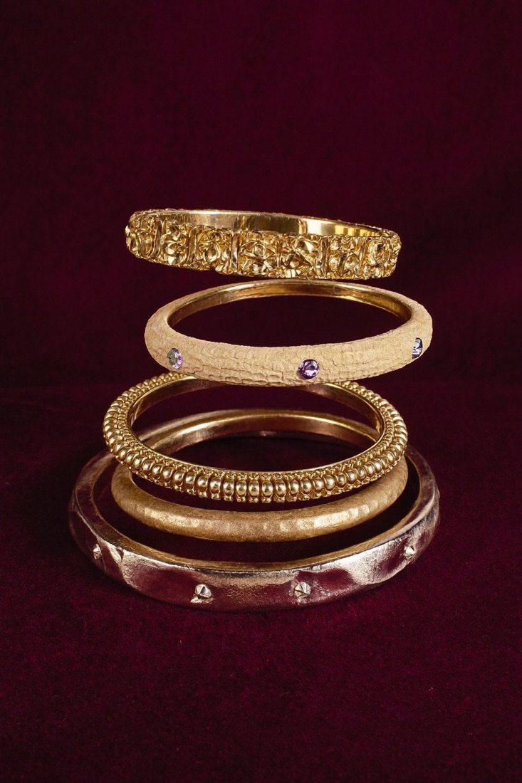 A stack of six gold-tone bangles